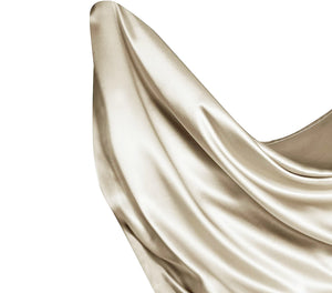 Satin flat sheet in light gold floating in the air