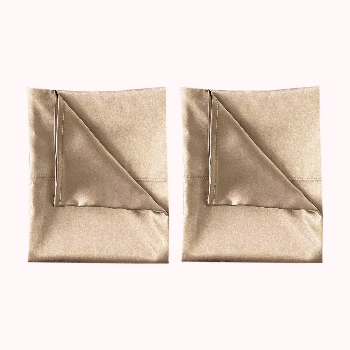2 folded satin pillowcases in light gold