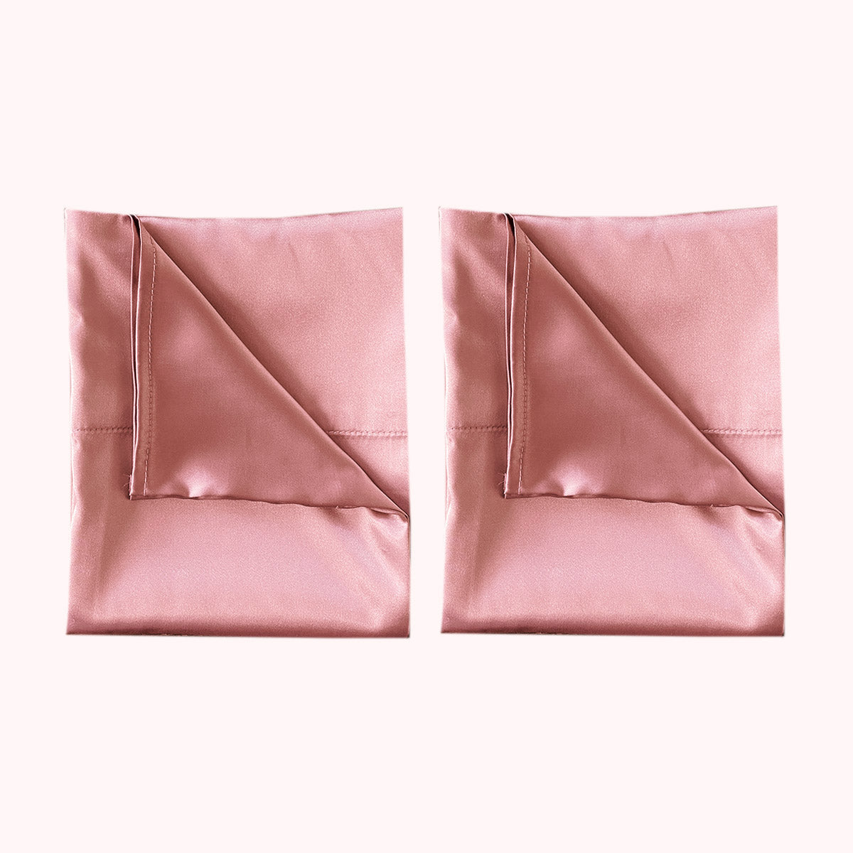 2 folded satin pillowcases in pink