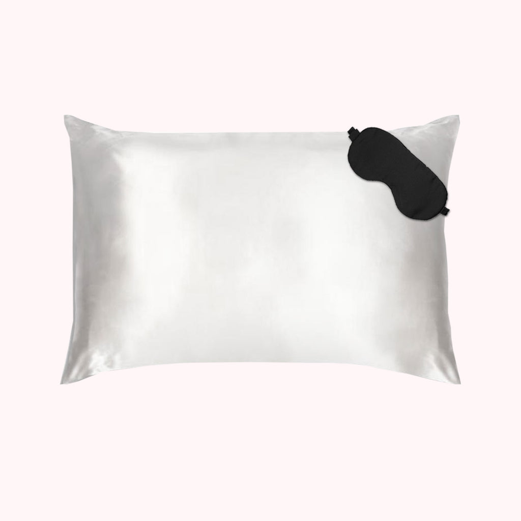 1 pillow encased in white silk pillowcase with black eyemask