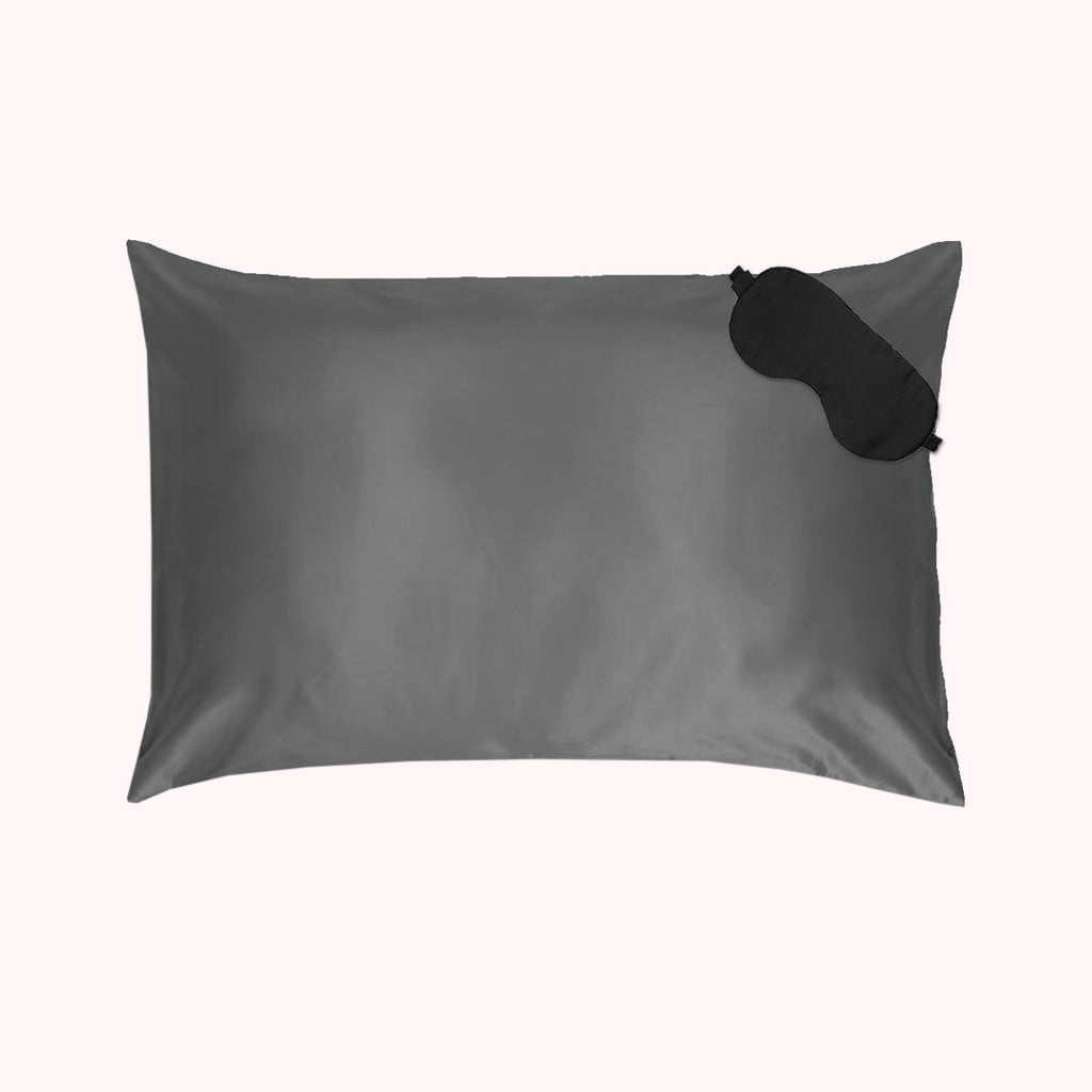 1 pillow encased in dark gray silk pillowcase with black eyemask