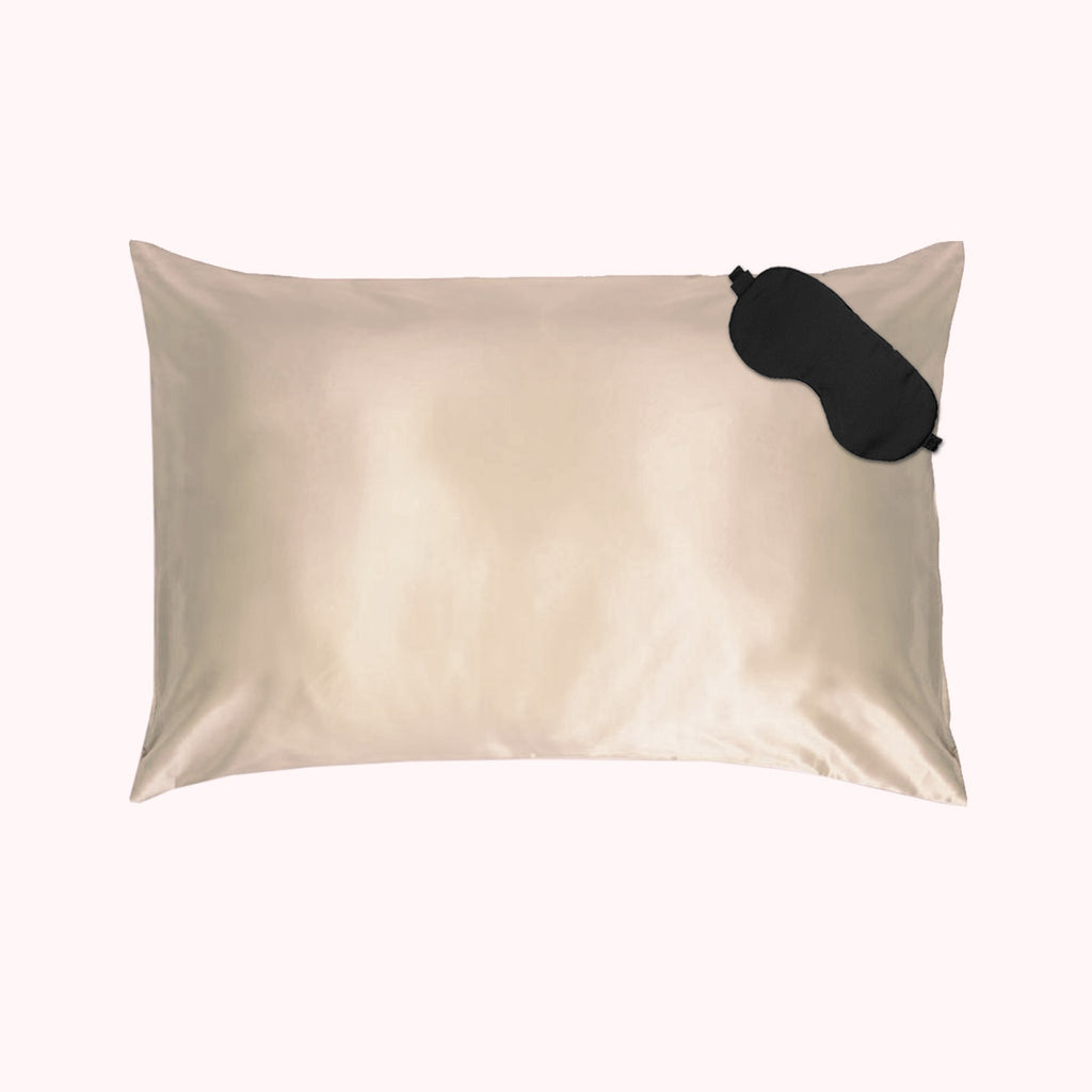 1 pillow encased in light gold silk pillowcase with black eyemask