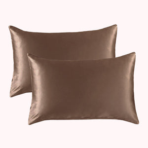 2 pillows encased in taupe satin pillowcases